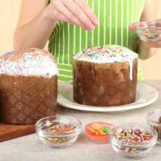 Woman decorating Easter cake, close up